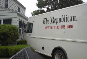 Springfield Republican truck with the slogan "where the news hits home" on the side hits a house.